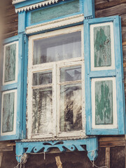 close-up of a window with blue shutters. Vintage rural architecture, decor, vintage
