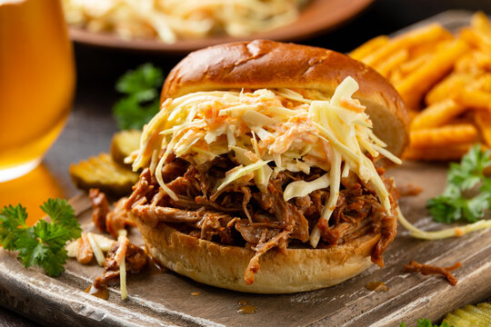 Homemade BBQ Pulled Pork Burger With Coleslaw, Fries And Beer