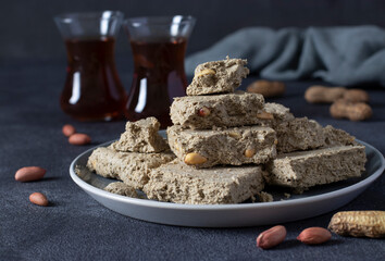 Tea ceremony with halva on dark gray background.