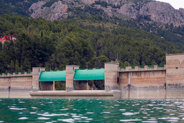 Guadalest reservoir, overlooking the open gates, on a cloudy day. 