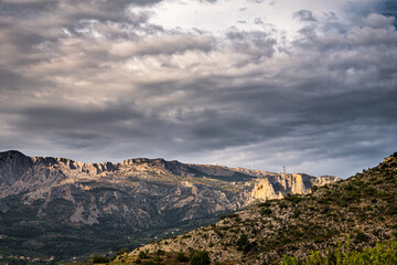 Fototapeta premium Natural landscape of the mountains in the interior of the province of Alicante (Spain), on a day with some clouds.