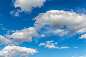 Naklejka na ściany i meble Blue sky with white beautiful clouds as an abstract background.