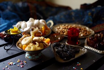 Eastern sweets. Dried fruits. Nuts. Haze from an extinguished candle.