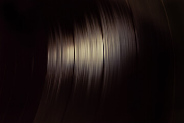 Close-up of a spinning vinyl record. Top view. Copy space. Concept of retro style, analogic...