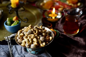 Plate with mix nuts on a eastern styled table