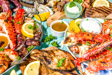 Assortment various barbecue Mediterranean grill food - fish, octopus, shrimp, crab, seafood, mussels, summer diet bbq party fest, with kebab, sauces, light blue sunny wooden background