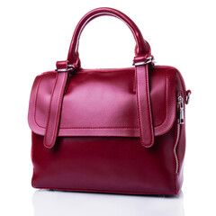 Red leather bag for women. Square shape. Two short handles for carrying the bag in the hands. On a...