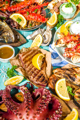 Assortment various barbecue Mediterranean grill food - fish, octopus, shrimp, crab, seafood, mussels, summer diet bbq party fest, with kebab, sauces, light blue sunny wooden background