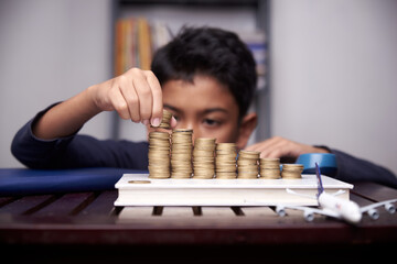 Asian boy saving money for education