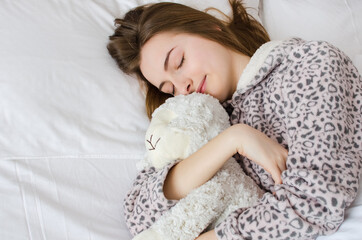 Happy young woman with blonde hair sleeping