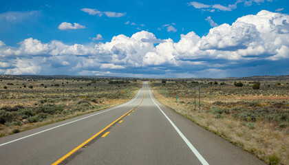 Highway in countryside USA. Empty national road, crossing American desert, Blue cloudy sky background