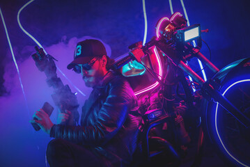 Obraz na płótnie Canvas A special force agent with a rifle is hiding behind a futuristic motorbike and shooting. Cyberpunk concept.
