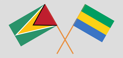 Crossed flags of Guyana and Gabon. Official colors. Correct proportion