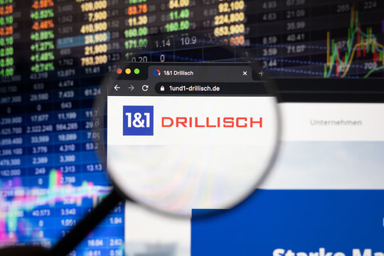 1 und 1 Drillisch company logo on a website with blurry stock market developments in the background, seen on a computer screen through a magnifying glass