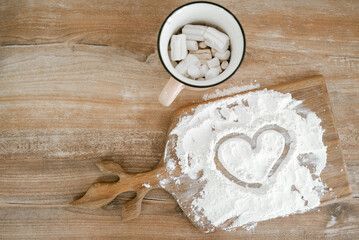 Drawing of a heart in flour. Romantic greeting card with a copy of the space.