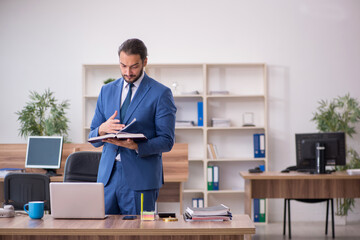 Young male employee working in the office