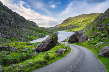Winding road going between two halves of split rock or boulder in Gap of Dunloe, Black Valley, MacGillycuddys Reeks mountains, Ring of Kerry, Ireland © Dawid