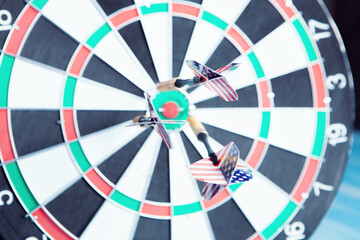 dart arrow hitting in the target center of dartboard.