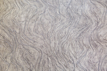 Background of the wall with lilac and white paint with a beautiful pattern of wavy lines vertically. Design backgrounds textures interior.