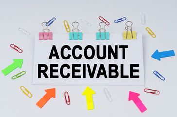 On the table there are paper clips and directional arrows, a sign that says - Account Receivable