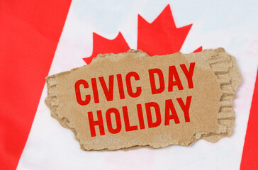 Against the background of the flag of Canada lies cardboard with the inscription - Civic Day Holiday