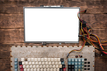 Blank screen with copy space and old computer keyboard on the wooden flat lay table background.