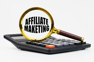 On a white background lies a calculator and a magnifying glass with the inscription - Affiliate Maketing