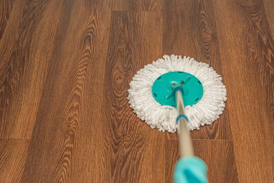 Floor Cleaning And Disinfection, House Wet Cleaning. Washing Vinyl Brown Floor With A Round Mop, House Cleaning, Place For Text