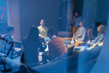Office workers and handicaped person in a wheelchair discussing business moments in a modern office. Disability and business concept