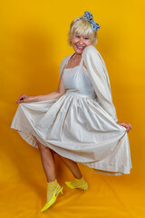 Funny portrait of mature woman. A beautiful lady is wearing a 50s style dress.