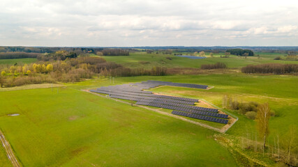 Photovoltaic panels installed on a green field outside the city, renewable energy farm