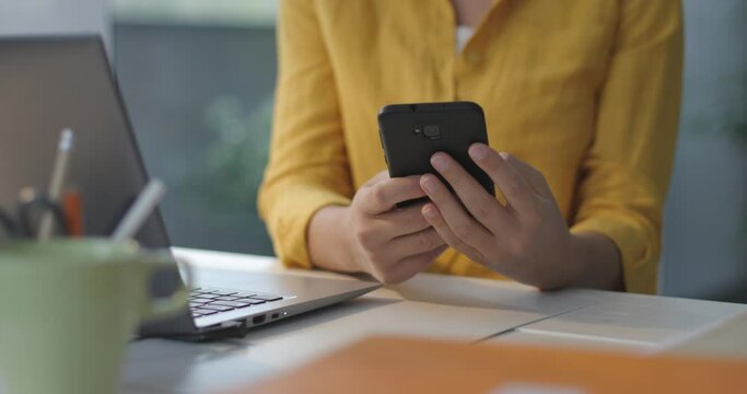 Woman sending messages with her smartphone