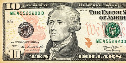 Front of the 10 USA dollar bill with a portrait of President Alexander Hamilton close-up