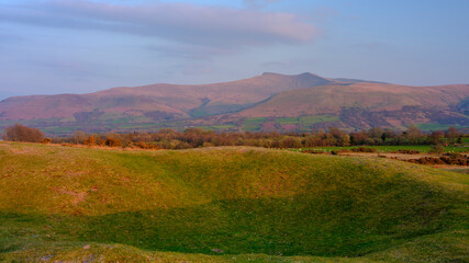 Golden hour view from Fan Frynych towards Pen y Fan and the peaks of the Brecon Beacons National Park, Wales, UK