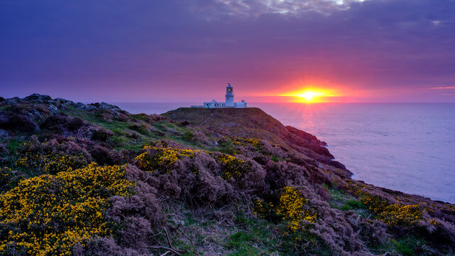 Sunset over Strumble Head light house, Wales, UK