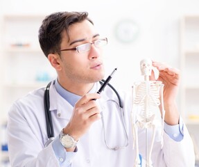 Doctor explaining human body on skeleton