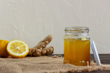 Lemon ginger jam in a glass jar on a wooden background, Antiviral product, Herbal medicine, Healthy food