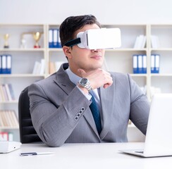 Businessman with virtual reality glasses in modern technology co