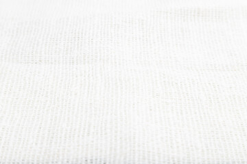 Fragment of smooth white linen tissue. Side view, natural textile background.