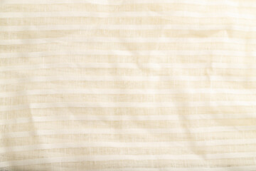 Fragment of smooth white linen tissue. Top view, natural textile background.