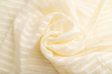 Fragment of white linen tissue. Top view, natural textile background.