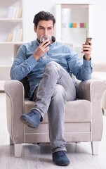 Young man drinking wine at home