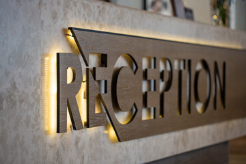 Reception sign on the desk in the hotel