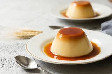 Fotobehang Cream caramel pudding with caramel sauce in plate on white rustic table © mescioglu
