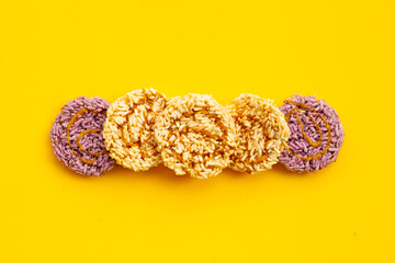 Rice cracker with coconut palm sugar on yellow background.