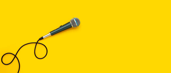 Microphone on yellow background.