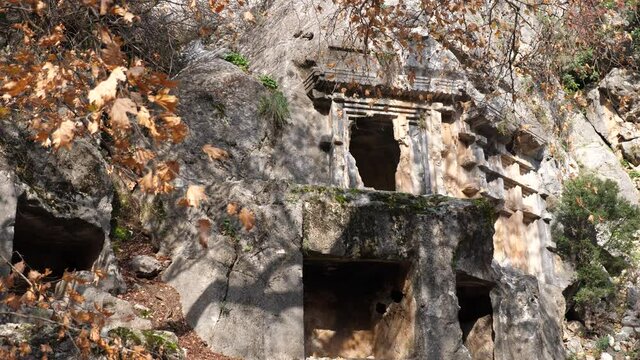 Remains of ancient Lycian rock necropol in Pinara ancient city in Turkey