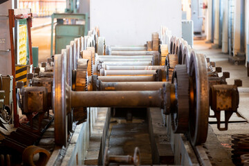 Ussuriysk locomotive repair plant. Steel wheels from a railway carriage lie in a large workshop.