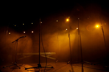 Empty concert stage with microphones and lighting in Paris - Powered by Adobe