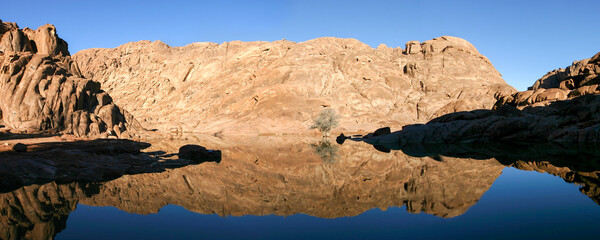 Wonderful lake in the desert of Sinai with sunrise with blue water and reflections, Egypt.